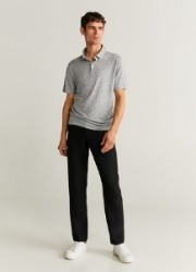 A person standing in a grey shirtDescription automatically generated